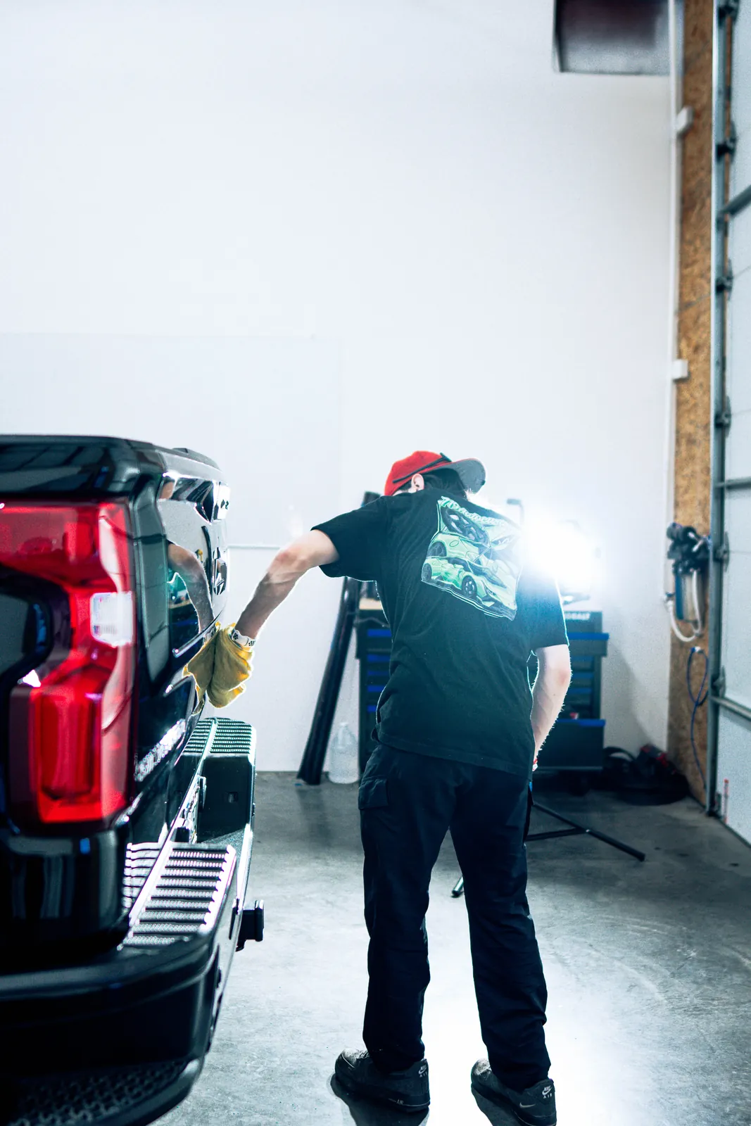 719 Auto Customs technicians applying ceramic coating in the shop
